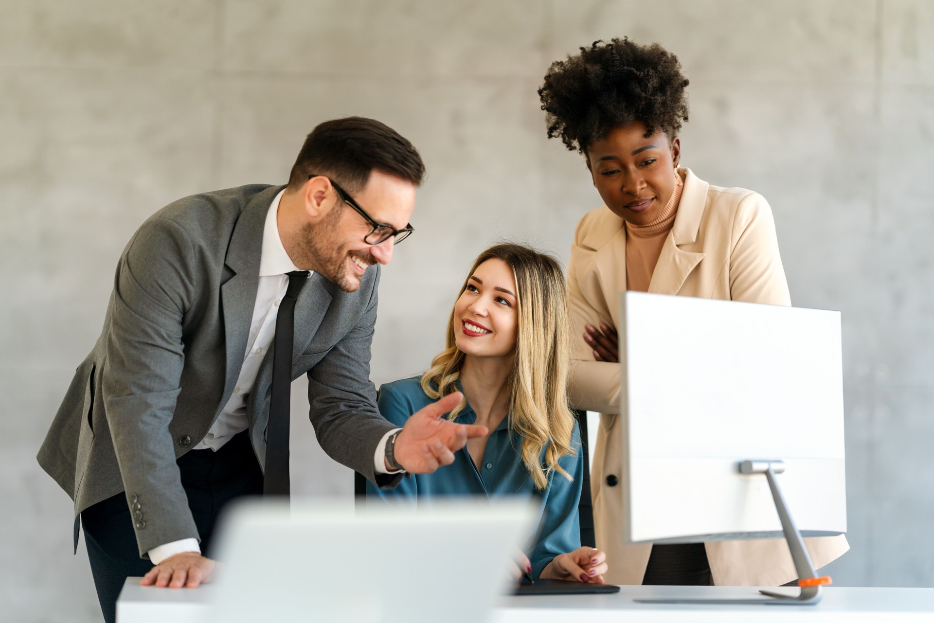 Portrait of successful business people working, talking together in corporate office during work.