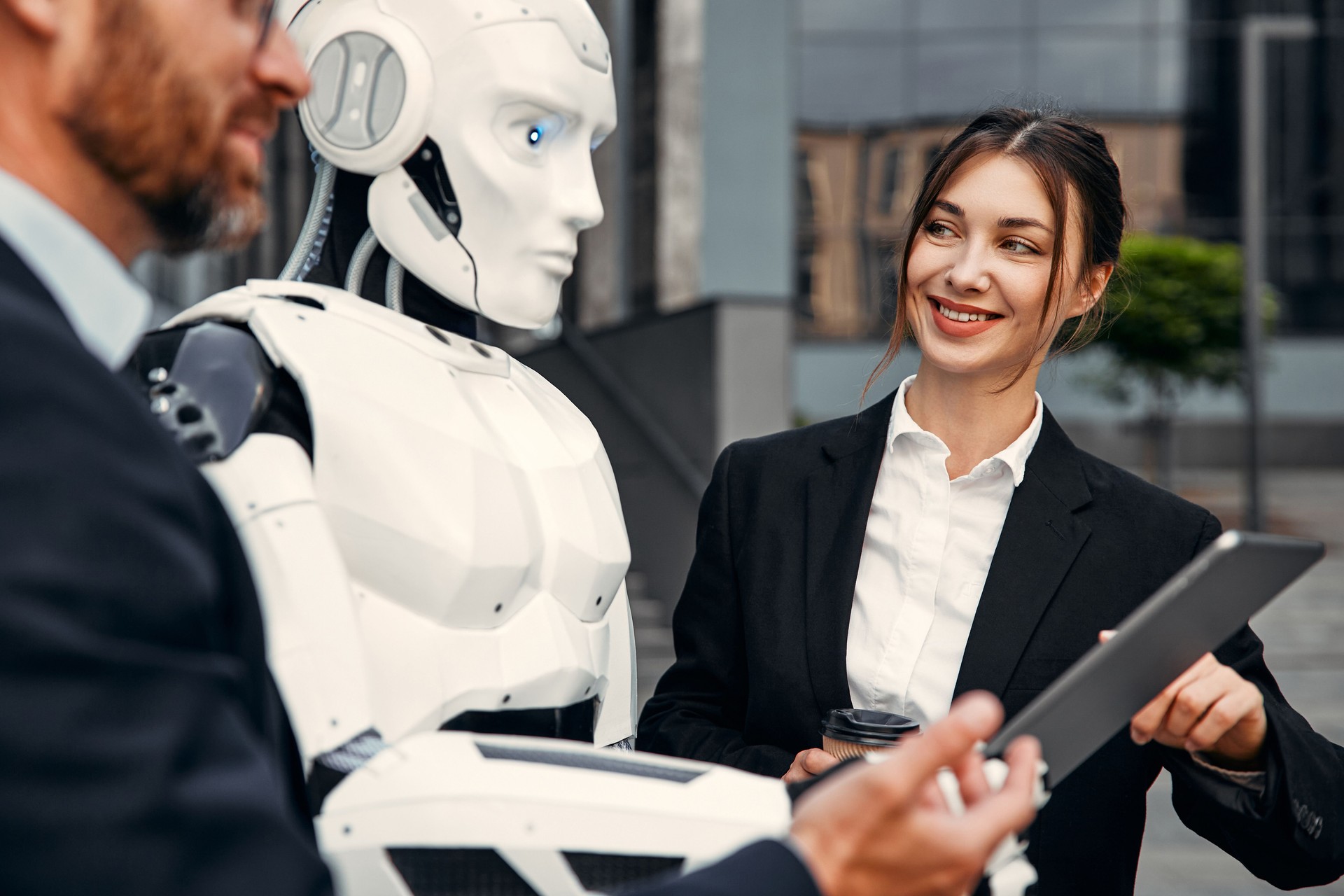 Robot with businessmen on the street near the building