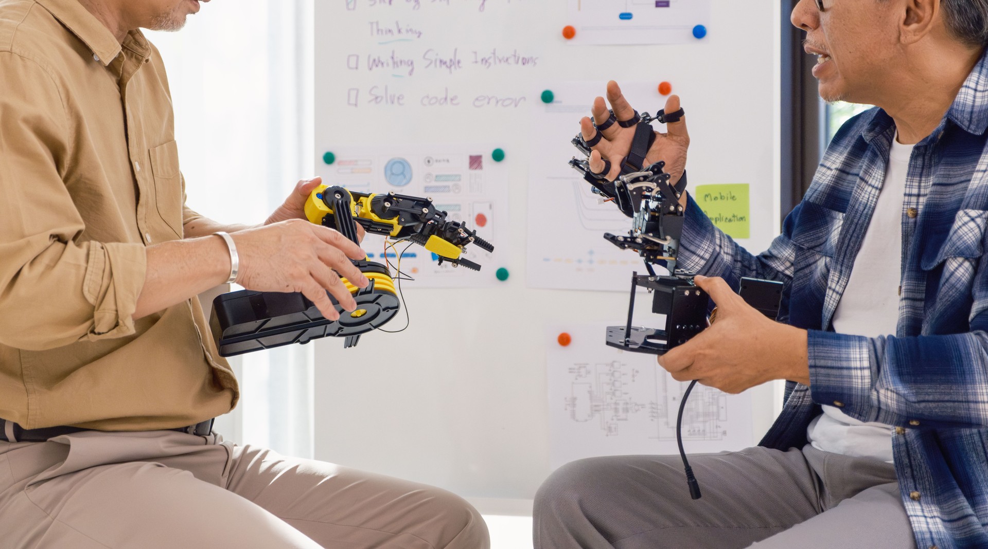 asian Engineers discussing robotics prototype with teamwork and innovation in artificial technology development